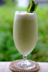 close up avocado smoothies on table background
