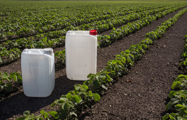 Canisters with pesticides in field