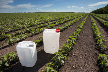 Canisters with pesticides in field