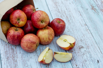 Organic ripe apples on a wooden table. Fresh cut apple healthy snack. Cooking ingredients. Harvest.