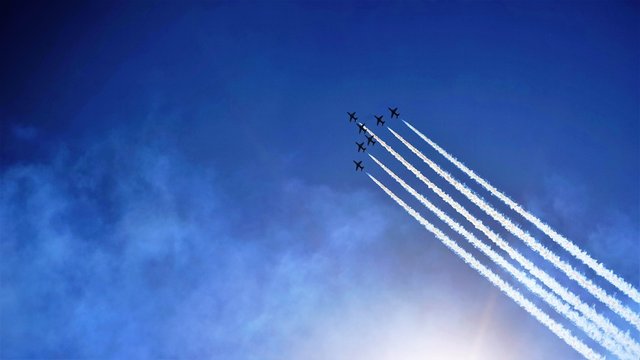 airplanes in the sky and white traces