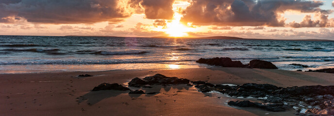 Golden light beach sunset reflection, Atlantic ocean on the west coast of Ireland