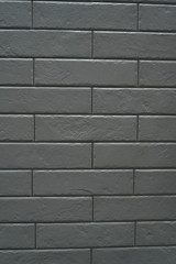 Close up abstract pattern of sandstone brick wall background in vintage tone style and vertical frame,