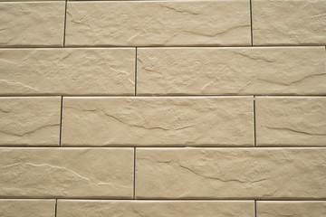 Close up abstract pattern of sandstone brick wall background in vintage tone style and vertical frame,