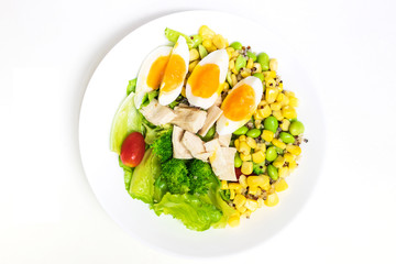 Vegetable salad with chicken breast and boiled egg. Salad with vegetables and grains isolated on white background. Top view
