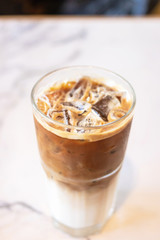 Iced latte coffee glass on table in cafe and restaurant.