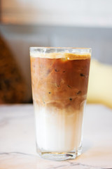 Iced latte coffee glass on table in cafe and restaurant.