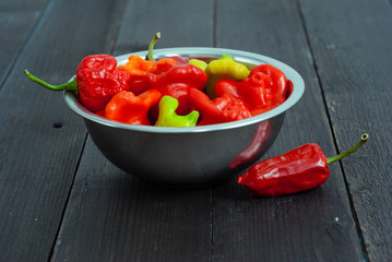 chili peppers on black wood table