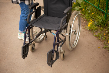 Fototapeta na wymiar Wheelchair. Armchair for transporting people with disabilities. Medical equipment to make life easier for people with motor disease