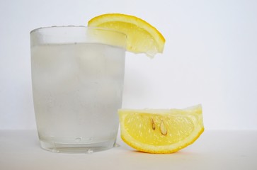 a glass of water and a lemon slice