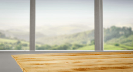 Wooden desk of free space and blurred background of window space 