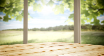 Wooden desk of free space and blurred background of window space 