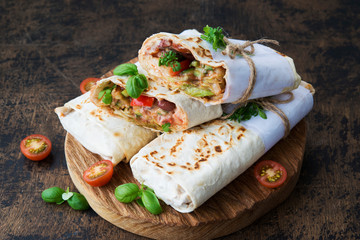 Mexican wrapped burrito with red beans and vegetables