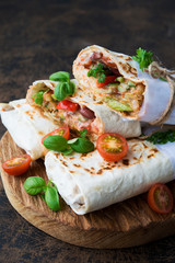 Mexican wrapped burrito with red beans and vegetables
