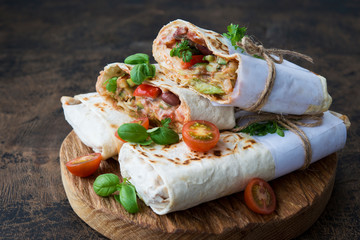 Mexican wrapped burrito with red beans and vegetables