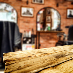 Fototapeta na wymiar Wooden desk of free space and barber shop interior 