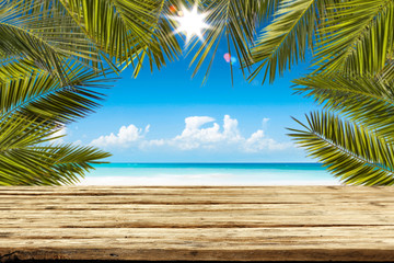 Summer background of beach and wooden desk of free space 