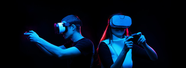 Couple with virtual reality headset are playing game.
