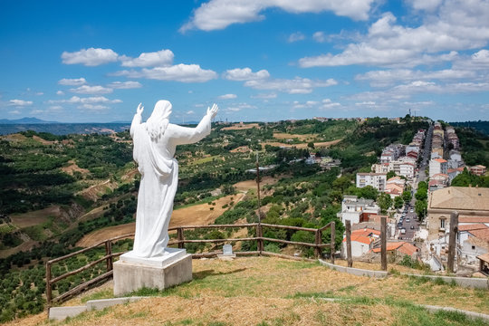 The statue of Christ the Redeemer over the town of Pomarico. Basilicata, Italy