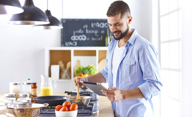 Smiling and confident chef standing in large kitchen