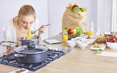 Young Woman Cooking in the kitchen. Healthy Food