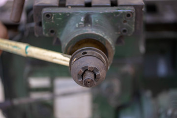 Repair of old metal lathe machine for metalworking closeup in workshop