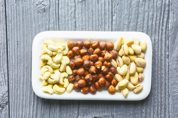 mixed nuts on a wooden table, top view