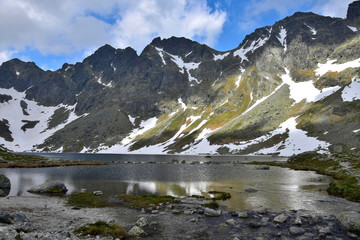 Naklejka na ściany i meble The mountain lake Vel'ke Hincovo pleso with the Mengusovske mountains in the High Tatras.