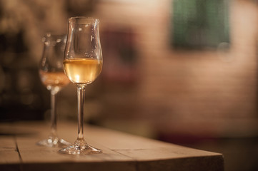 Two tasting glasses of whiskey served on wooden planks