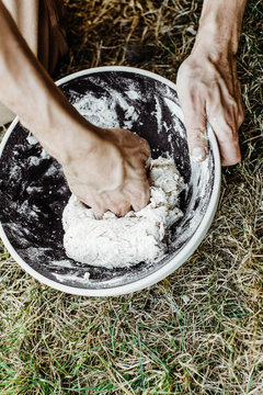man making bread in a bowl