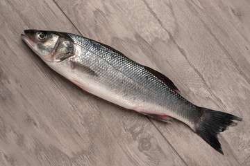 Sea bass fish on a wooden table