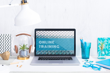 Computer staying on a table & showing the screen. Trendy & vibrant design. Geometry. Innovational digital internet applications & web business solutions. Modern workspace in an office. Development.