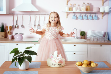 Little girl in a beautiful dress in the kitchen.