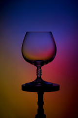 Empty tall ognac on a colourful background