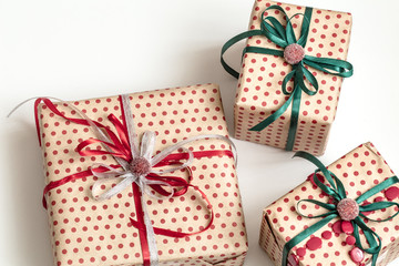 Christmas composition of various gift boxes wrapped in craft paper and decorated with satin...