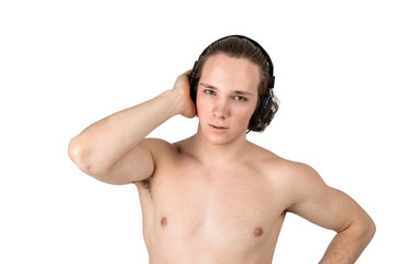 Fototapeta premium Handsome naked young man in towel listening to music in headphones on white background isolated