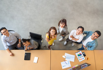 Top view portrait of Asian creative business team. Hipster Creative Startup Young business people in modern office. © saksit