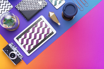 Man holds a tablet and looks at the screen. Mobile development. Innovational online businesses. Internet technologies. Trendy design. Geometry. Fashionable vibrant colors. Using a device. UX and UI.