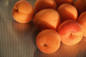ripe, juicy, orange apricots on the grey table