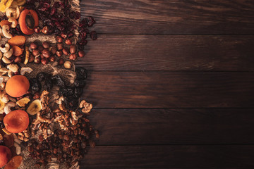 Mix of dried fruit and nuts arranged on linen fabric and an old table. Composition in the old style...