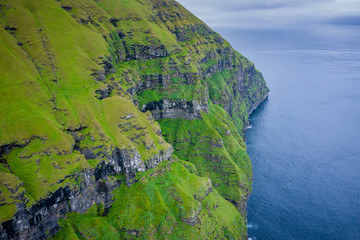 Aerial view of Koltur island in Faroe Islands, North Atlantic Ocean. Photo made by drone from above. Nordic Natural Landscape.