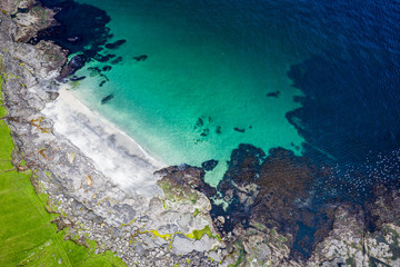 Naklejka na ściany i meble Aerial view of Koltur island in Faroe Islands, North Atlantic Ocean. Photo made by drone from above. Nordic Natural Landscape.