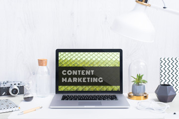 Computer staying on a table & showing the screen. Trendy & vibrant design. Geometry. Innovational digital internet applications & web business solutions. Modern workspace in an office. Development.