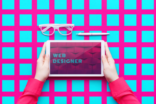 Man holds a tablet and looks at the screen. Mobile development. Innovational online businesses. Internet technologies. Trendy design. Geometry. Fashionable vibrant colors. Using a device. UX and UI. - Powered by Adobe