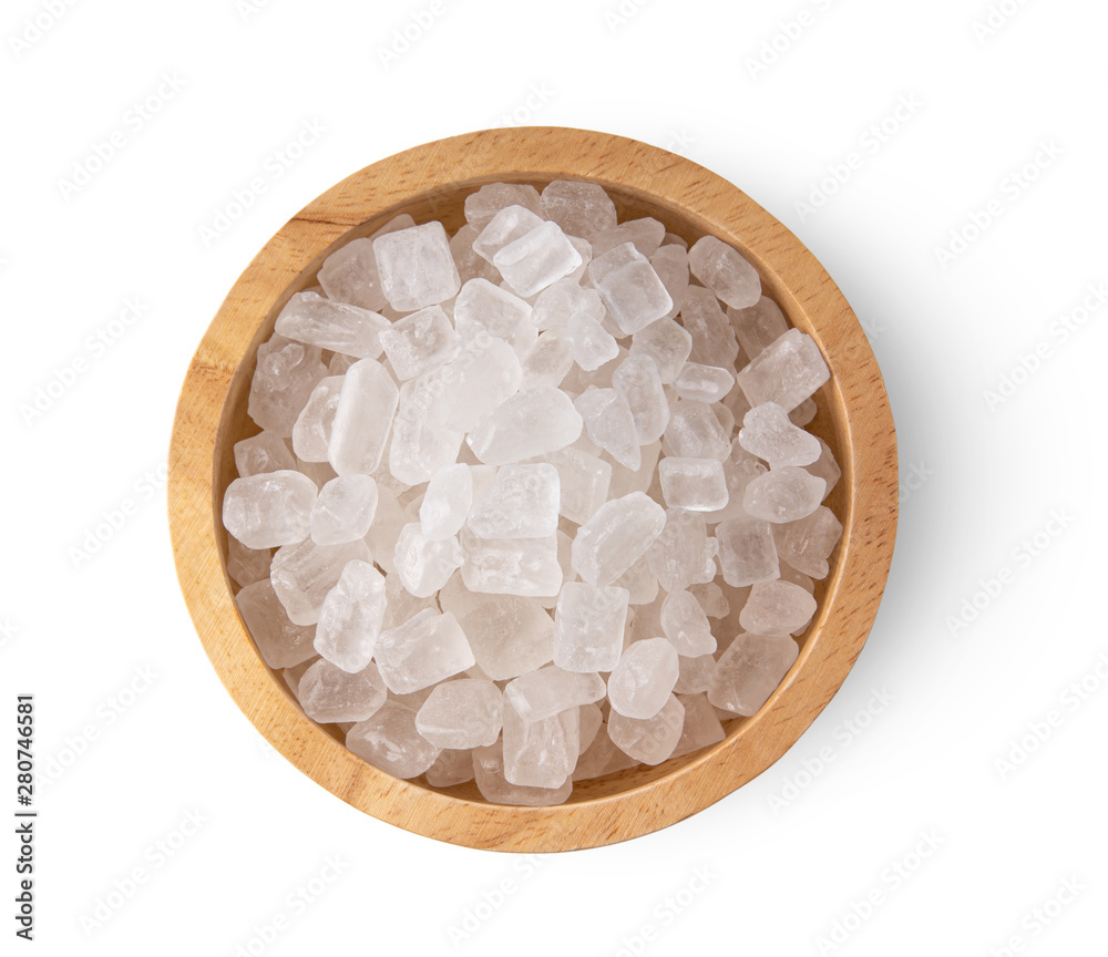 Wall mural candy rock sugar in wood bowl isolated on white background. top view