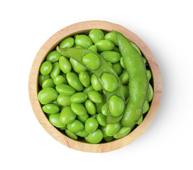 Green soy beans in wood bowl isolated on white background top view.