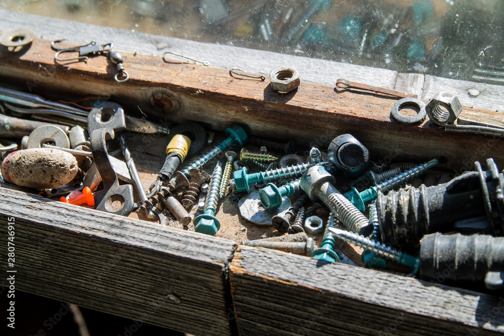 Wall mural wooden tool box of screws, anchors, nails, bolts. tool set of dowels, tool kit