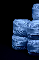 Sewing threads. A lot of threads on a black background.