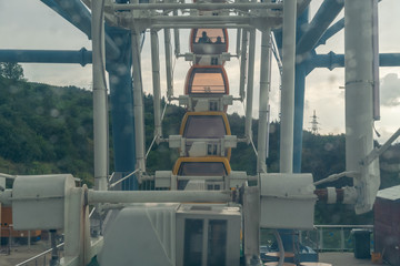 Ferris wheel in Tbilisi, ferris wheel cabins through glass with drops, Georgia.