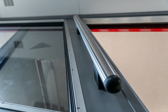 Metal handle in the elevator in order to hold on to it. Open the elevator door with mso glass